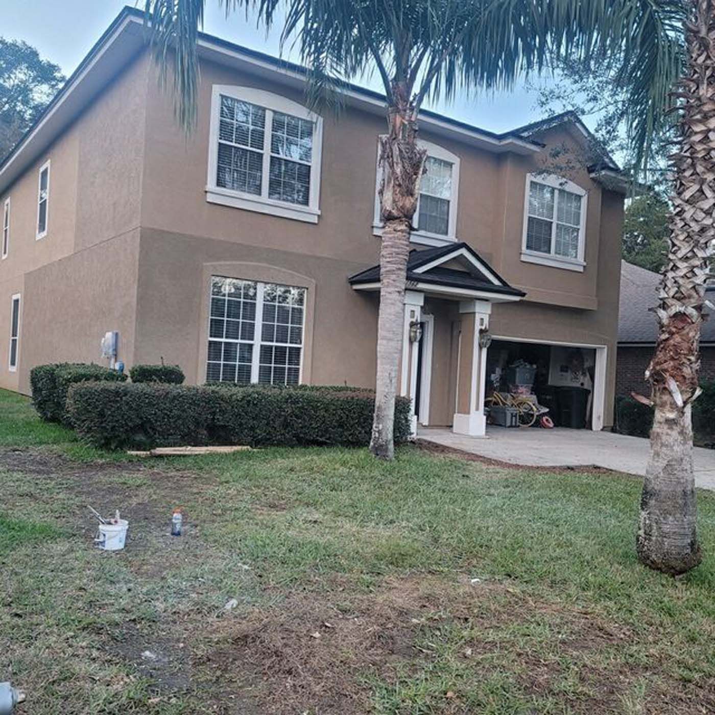 A house with a palm tree in front of it