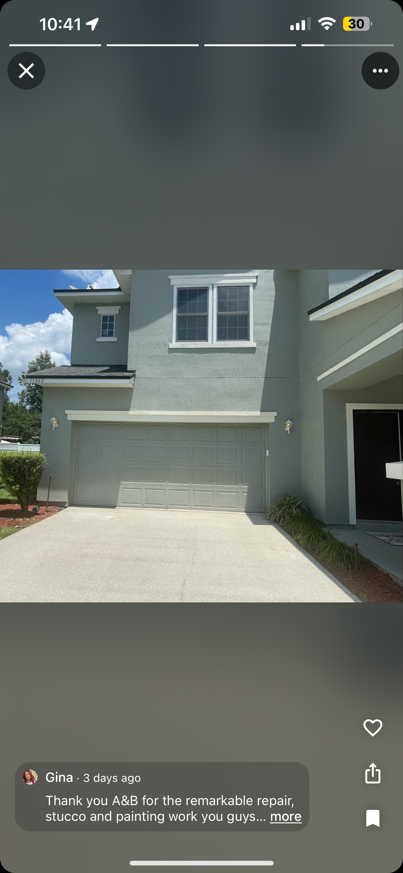 A phone screen shows a picture of a house with a garage door.