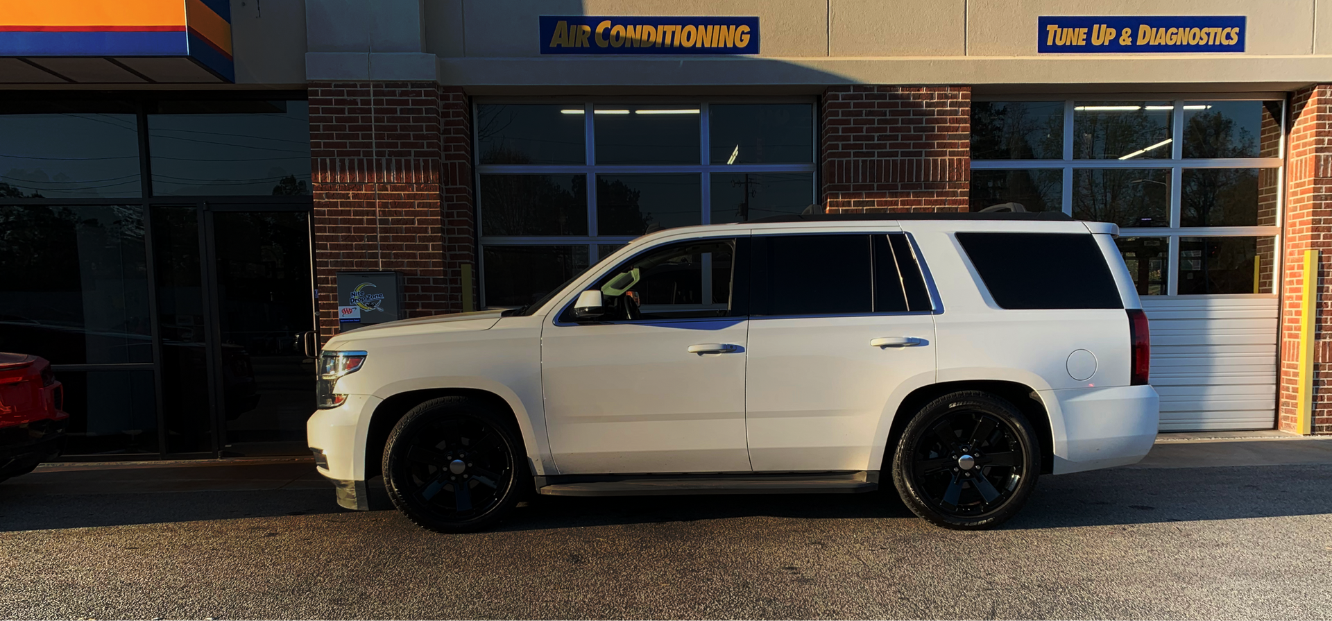 A white car is parked in front of a building | Dawson's Auto Care