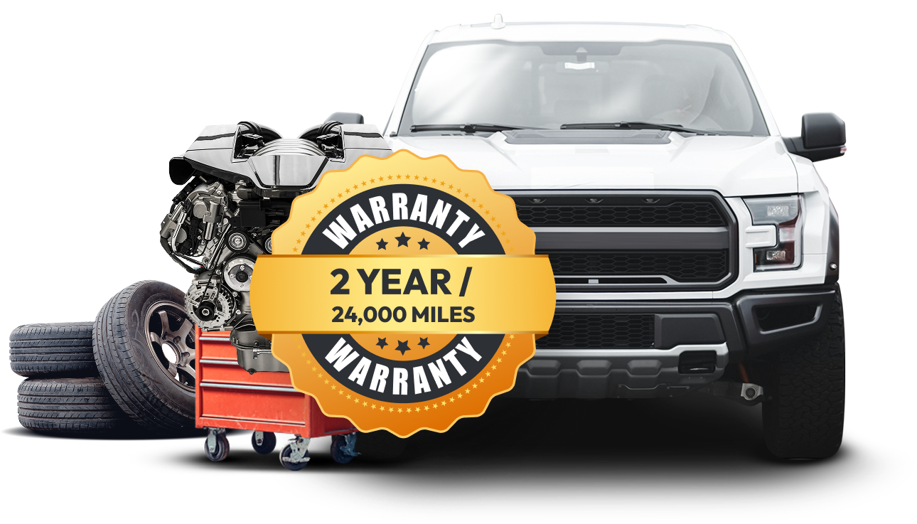 A white truck is parked next to a red toolbox and tires 