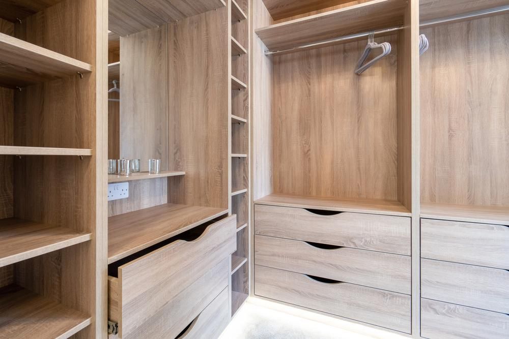 A Walk in Closet With Wooden Shelves and Drawers — PKJ Designs in Unanderra, NSW