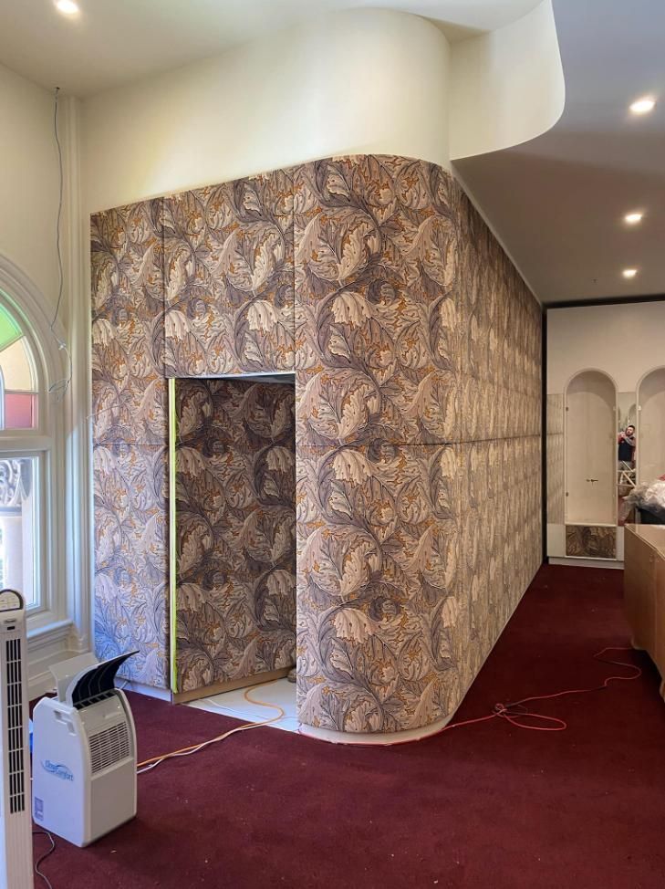 A Room With a Red Carpet and a Wall With a Patterned Wallpaper — PKJ Designs in Unanderra, NSW
