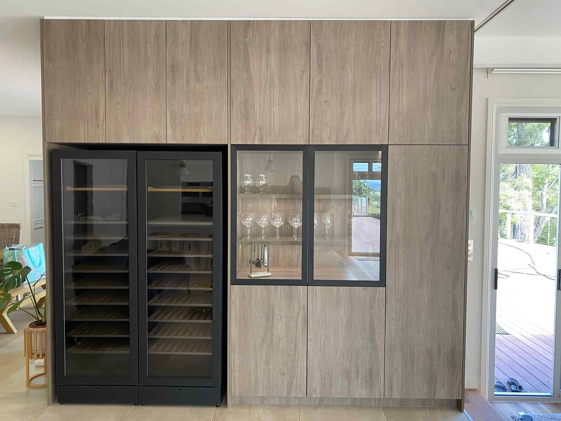 A Kitchen With a Wine Cooler and a Glass Door — PKJ Designs in Unanderra, NSW