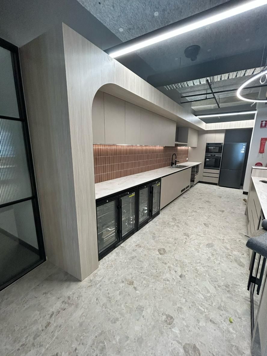 A Kitchen With a Lot of Cabinets and a Refrigerator — PKJ Designs in Unanderra, NSW