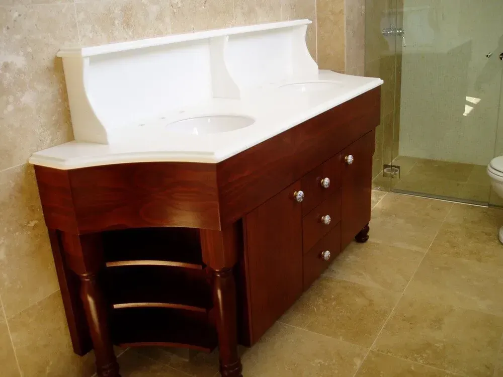 A bathroom with two sinks and a toilet