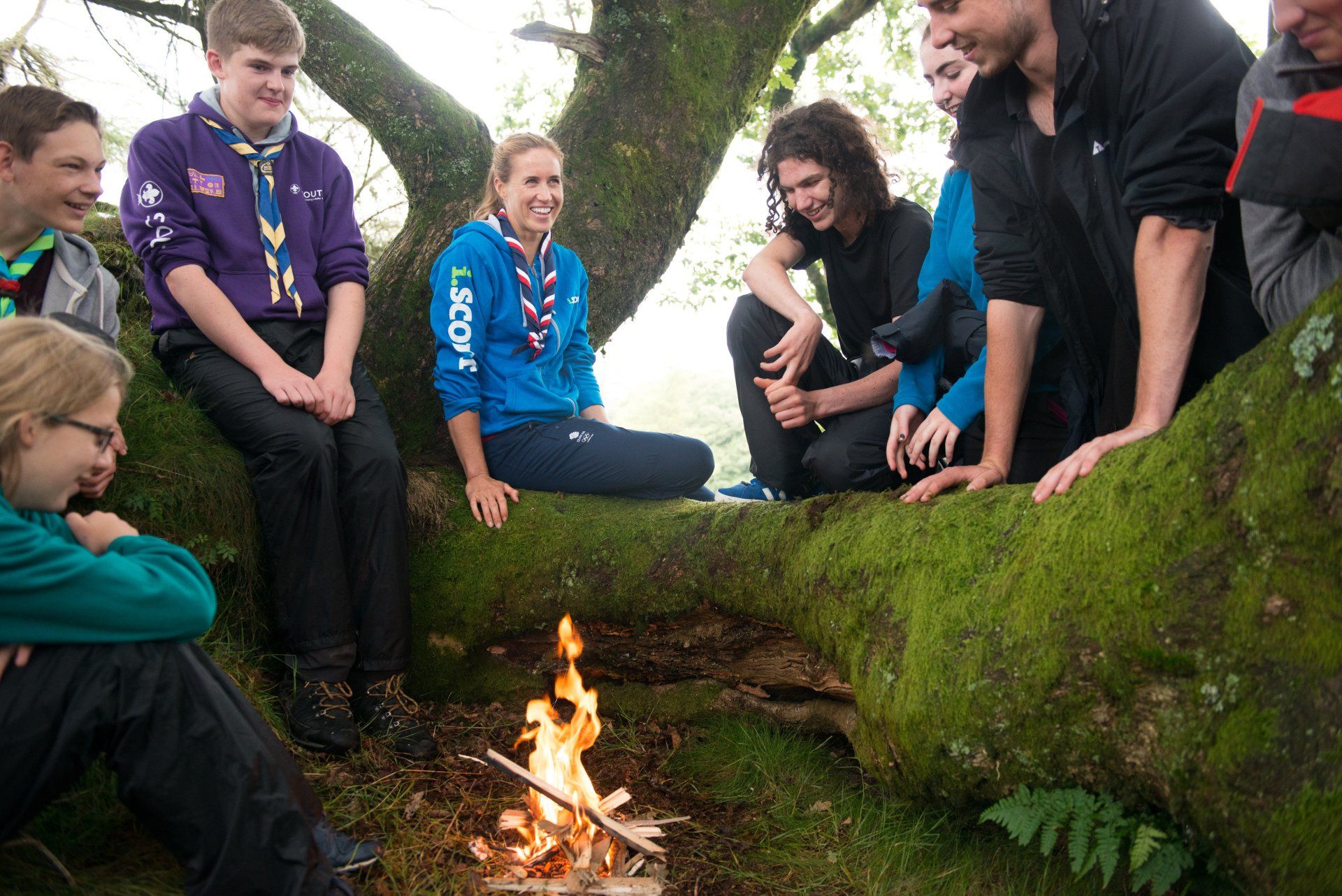 Helen Glover sat around a fire with Scouts