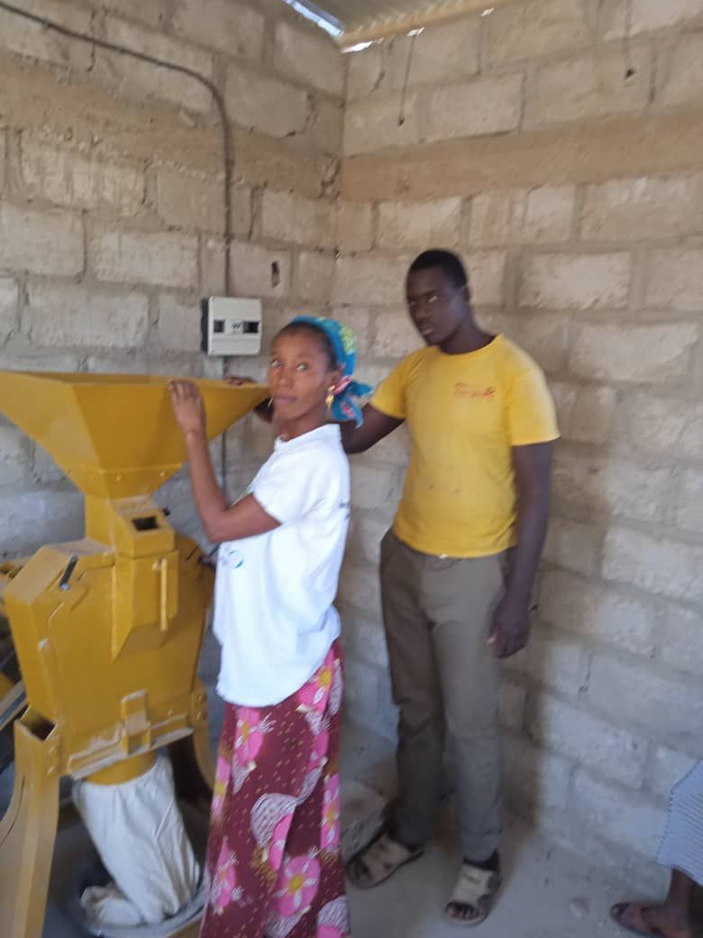 A man in a yellow shirt stands next to a woman in a white shirt
