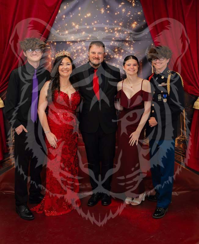 Five people pose for a photo in formal attire in front of a red curtain and star-patterned backdrop.