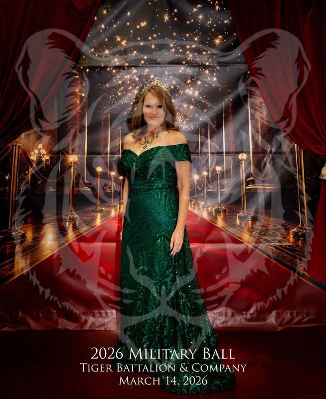 A person in a floor-length green gown poses before a backdrop for the 2026 Tiger Battalion Military Ball on March 14, 2026.