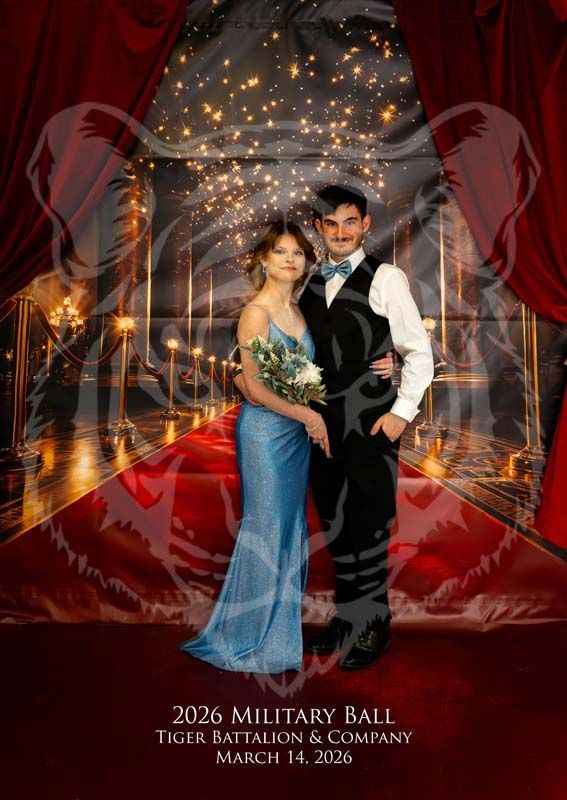 A couple poses on a red carpet at the 2026 Tiger Battalion Military Ball, wearing formal attire against a lit backdrop.