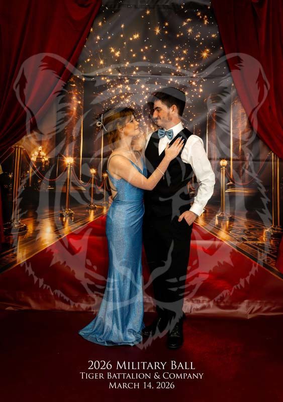 A couple in formal attire stands on a red carpet for the 2026 Military Ball, with a translucent tiger overlay.