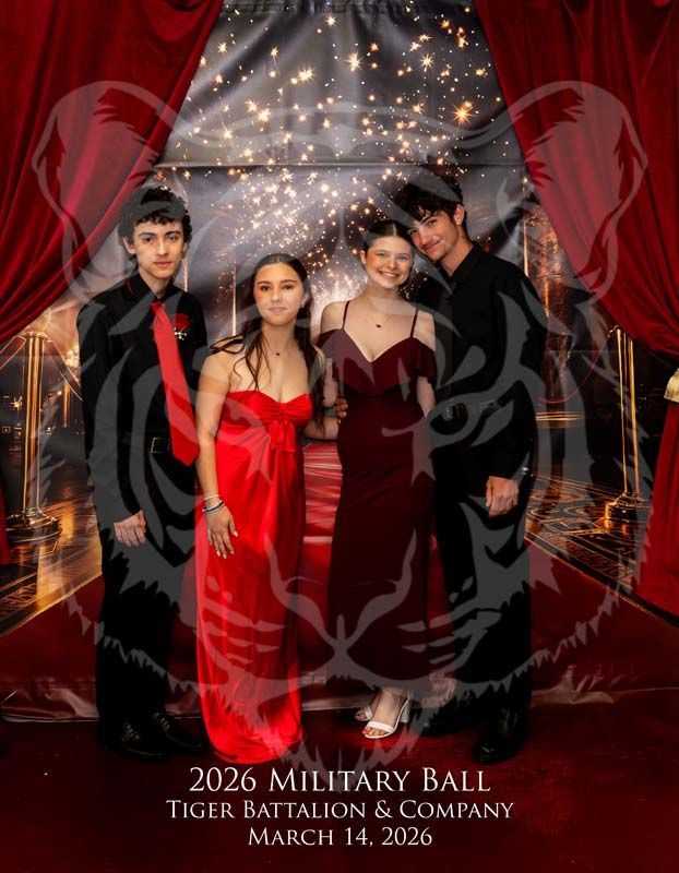 Four people stand in formal attire on a red carpet for the 2026 Military Ball, posed before a glowing, starry backdrop.