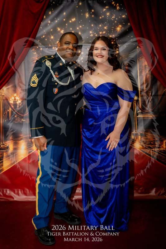 A person in a military dress uniform and a person in a blue formal gown pose together at a 2026 military ball.