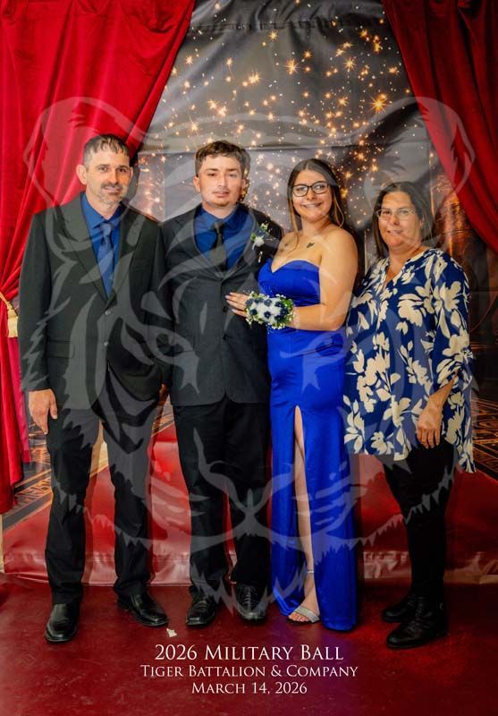 Four people pose in formal attire at the 2026 Tiger Battalion Military Ball in front of a red curtain and light backdrop.