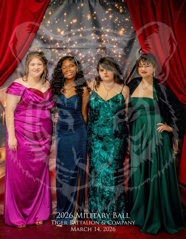 Four people in formal gowns stand before a red curtain and starry backdrop for the 2026 Military Ball.