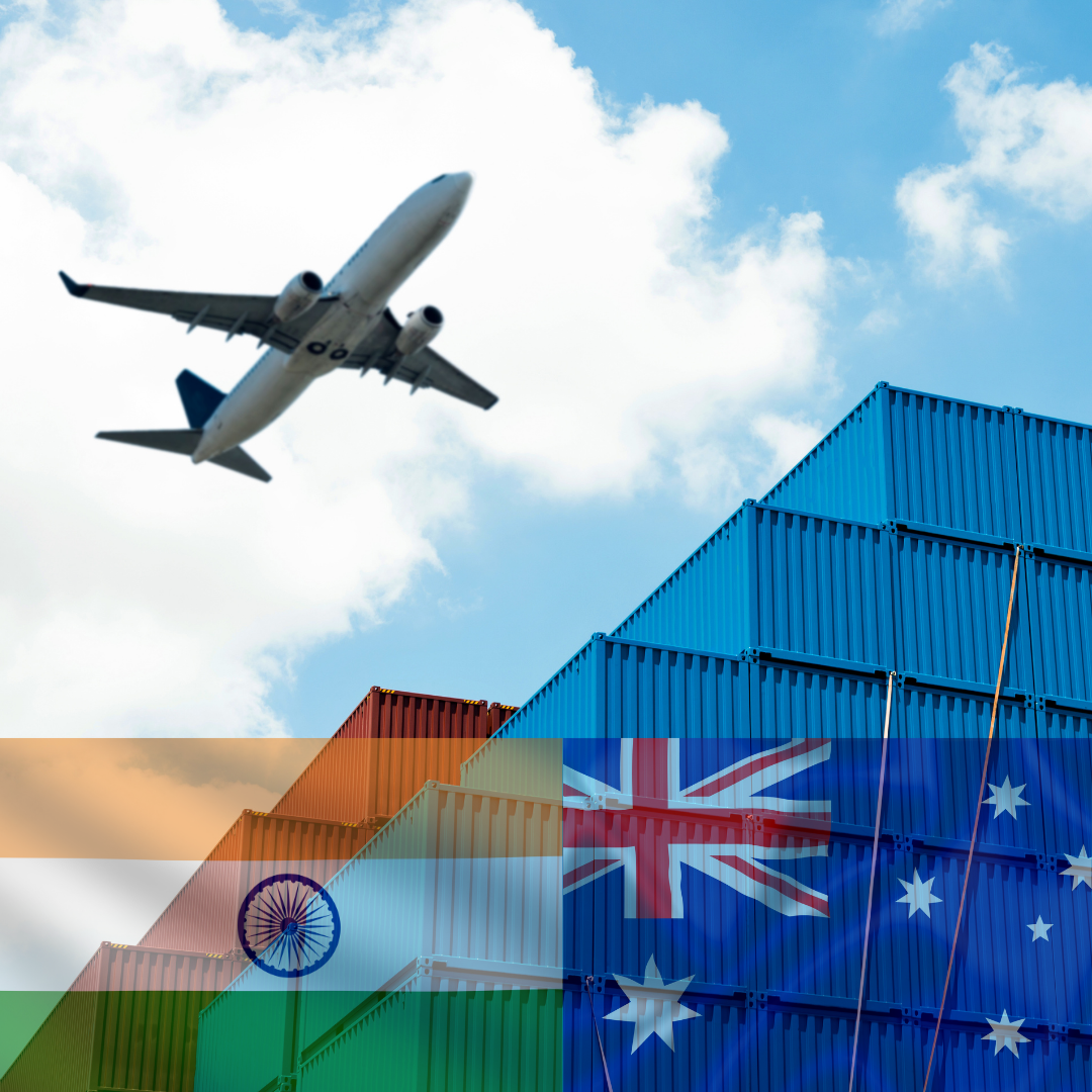 A plane is flying over a stack of blue shipping containers