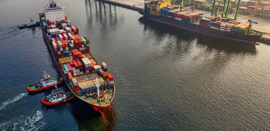 Port — Sydney, NSW — CFFC An aerial view of a large container ship docked in a harbor.