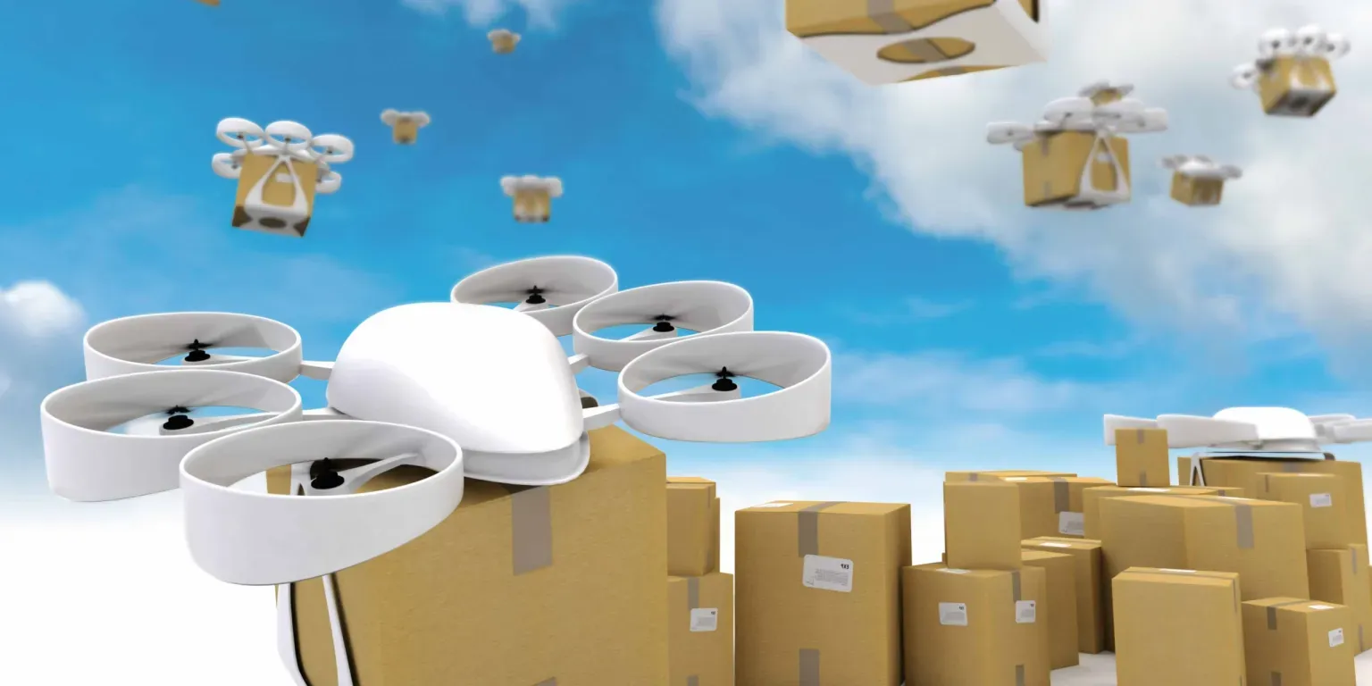 A drone is flying over a pile of cardboard boxes.
