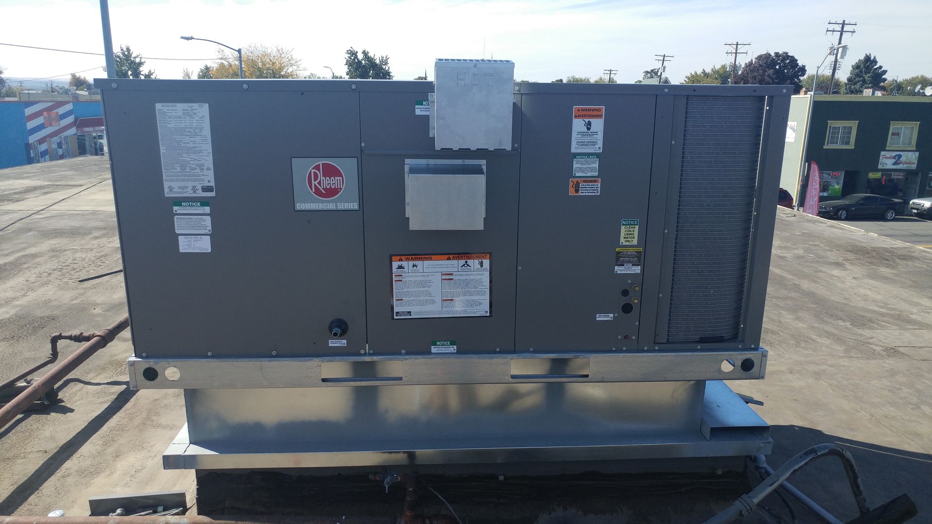 Black air ducts and pipes attached to a black ceiling.