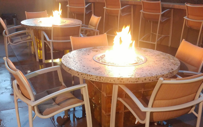 Flames rising from dark, reflective glass crystals; warm orange and yellow hues.