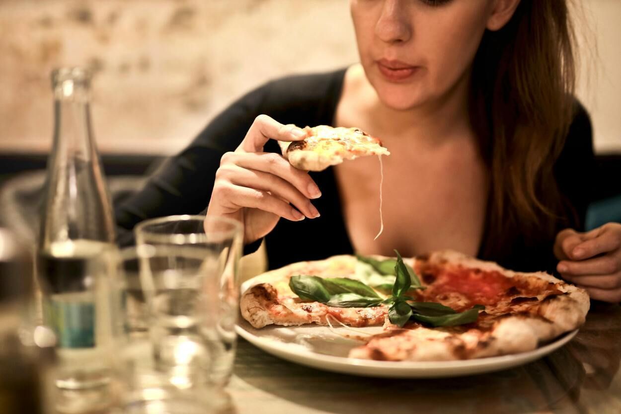 A woman eating a pizza