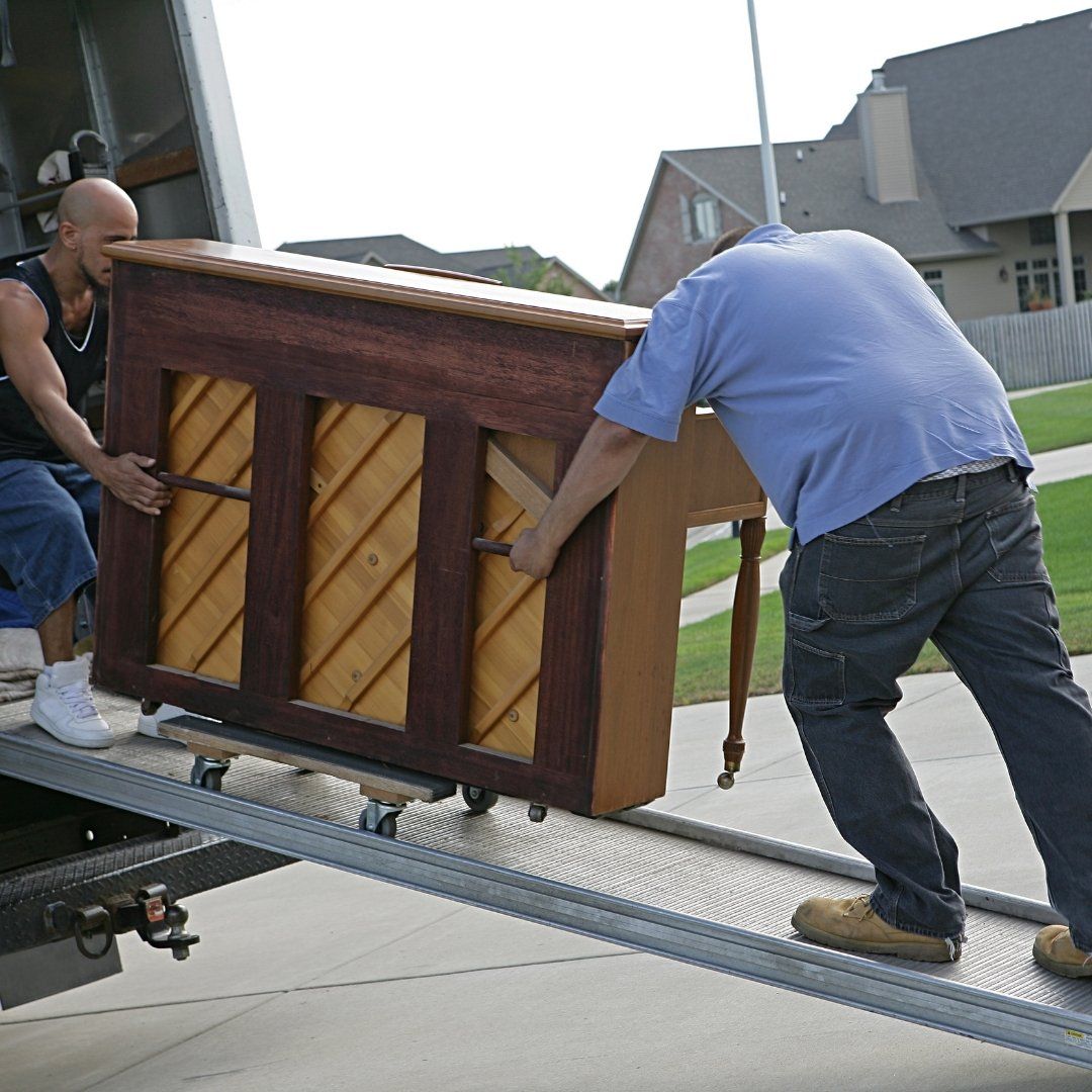 two men moving a piano