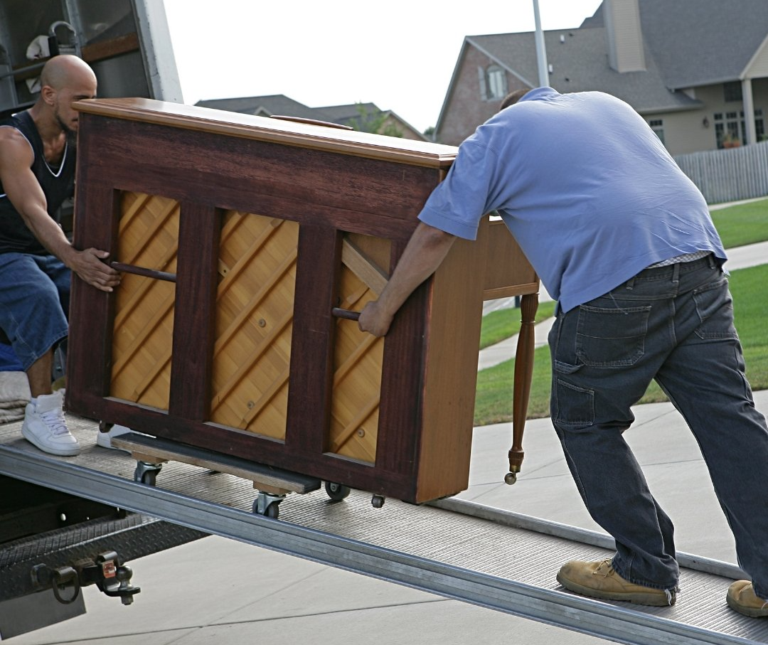 two movers moving piano