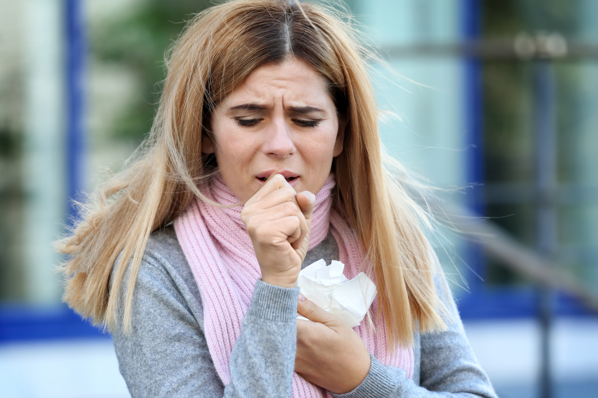 A woman coughing with a cold