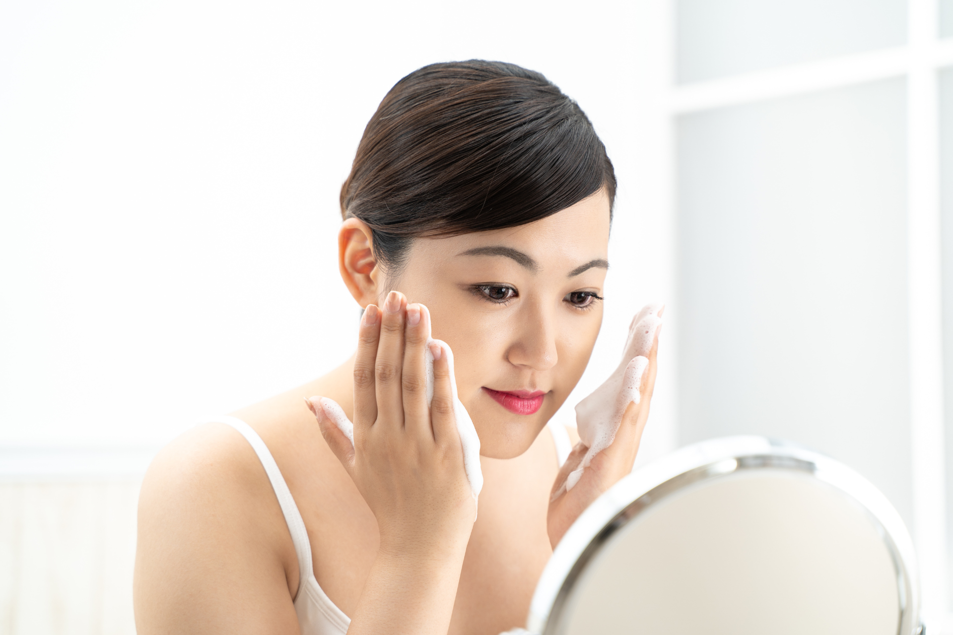 Woman Applying Cleanser