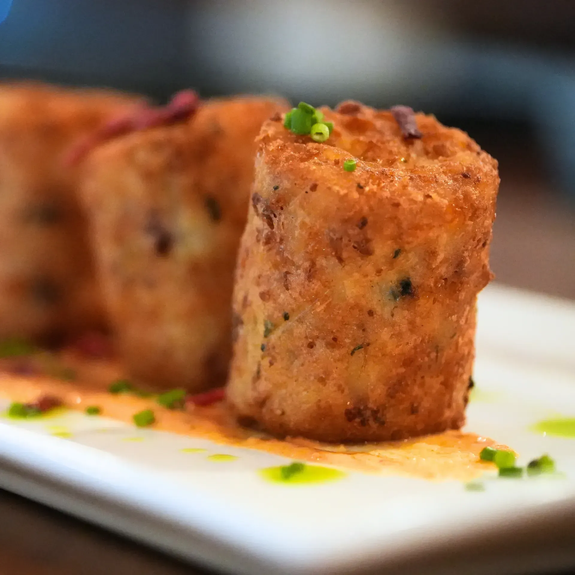 A close up of a white plate topped with fried food.