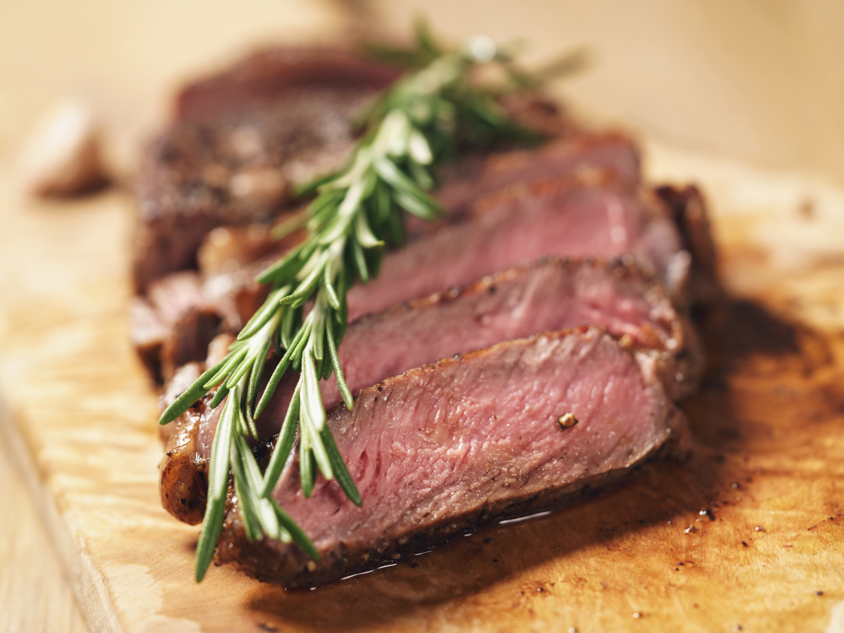 A patio with tables and chairs and umbrellas on a sunny day.
