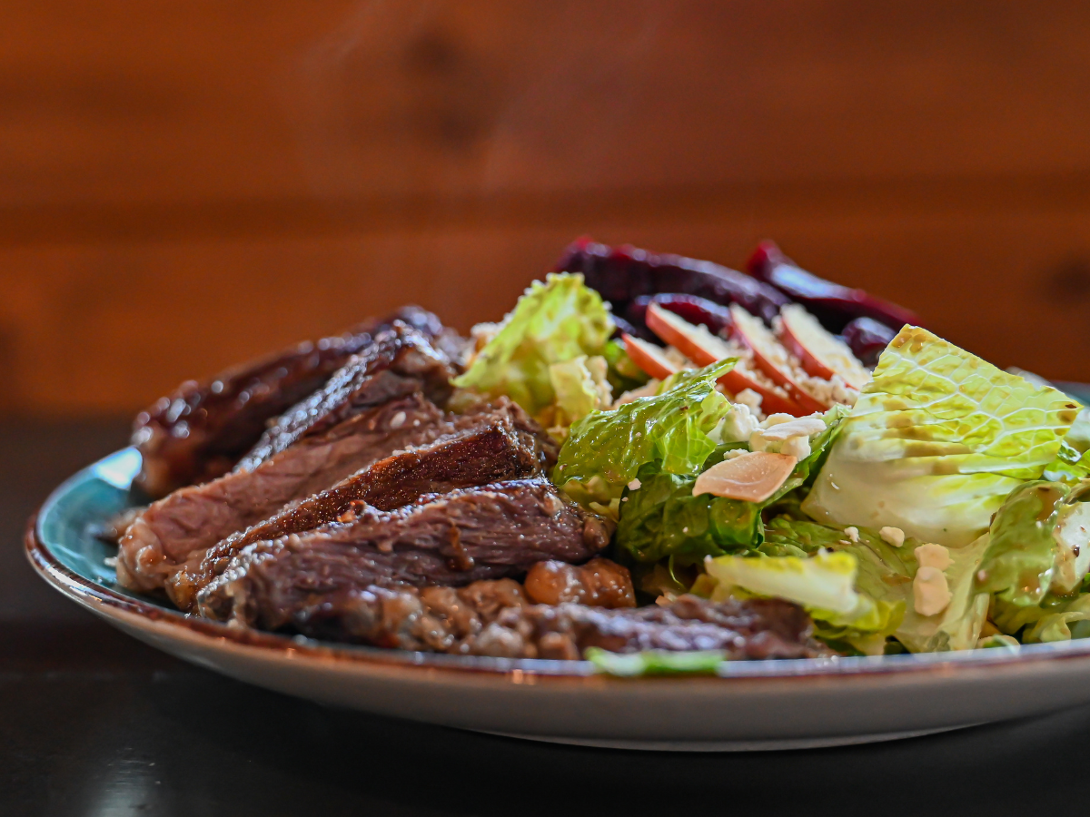 A patio with tables and chairs and umbrellas on a sunny day.