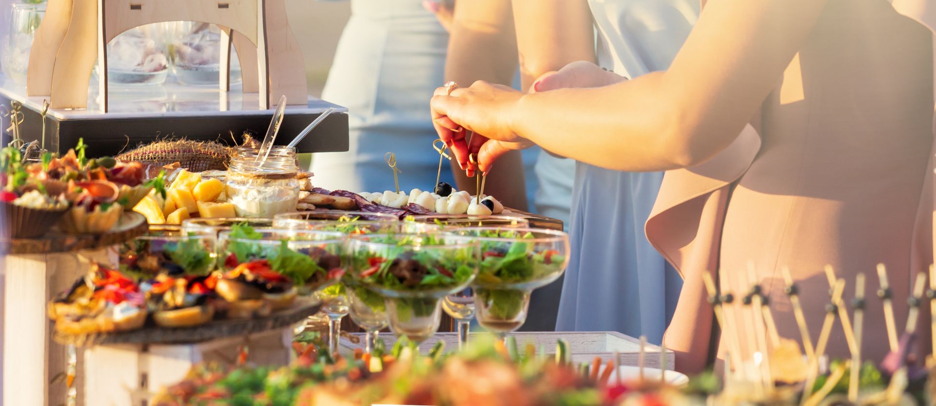 A close up of a plate of food with a glass of wine in the background.