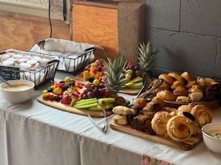 A patio with tables and chairs and umbrellas on a sunny day.