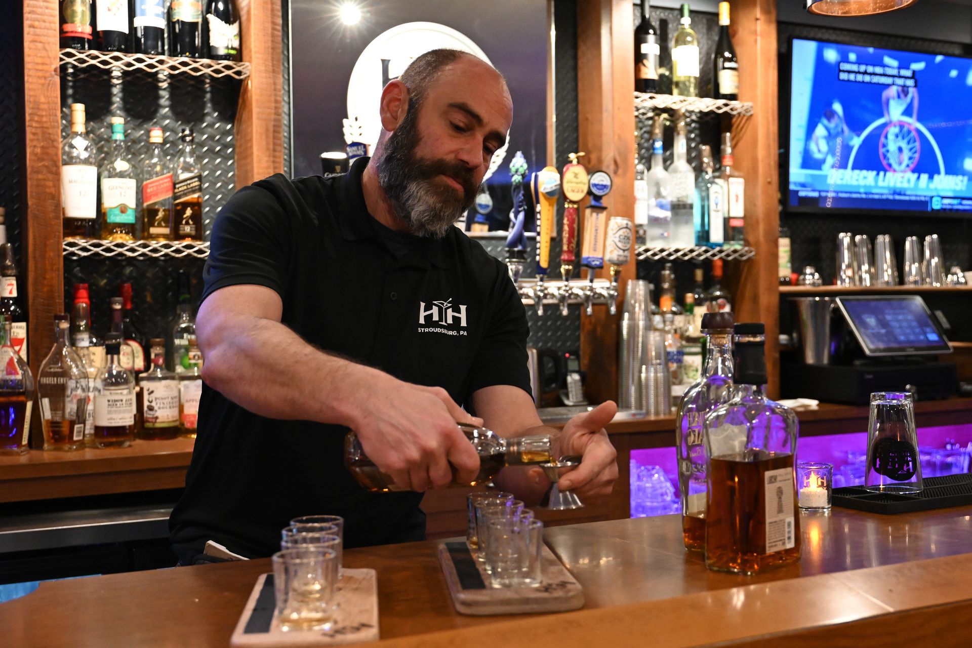 A patio with tables and chairs and umbrellas on a sunny day.