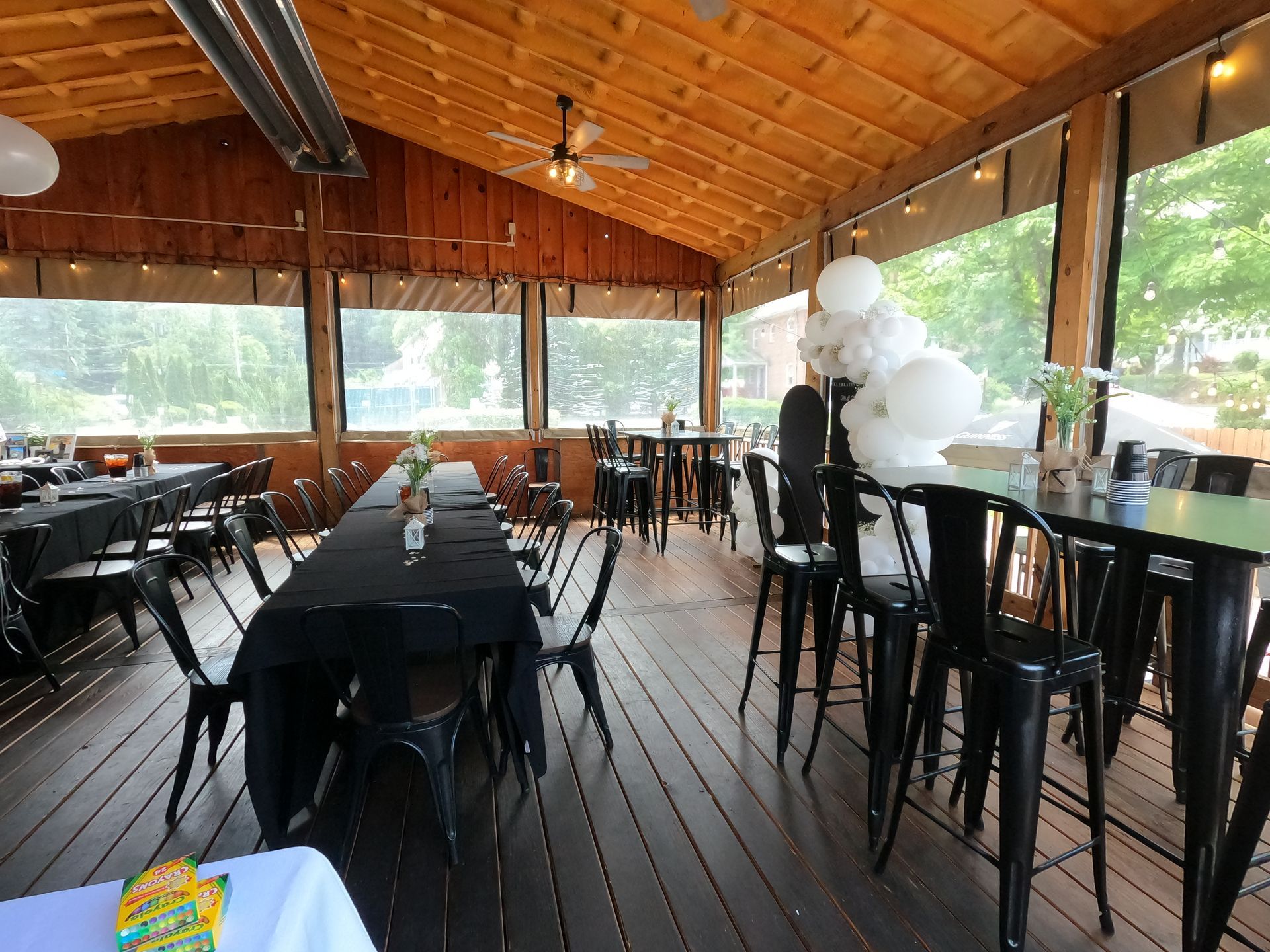 A large room with tables and chairs set up for a party at Happy Hour Bar & Grill