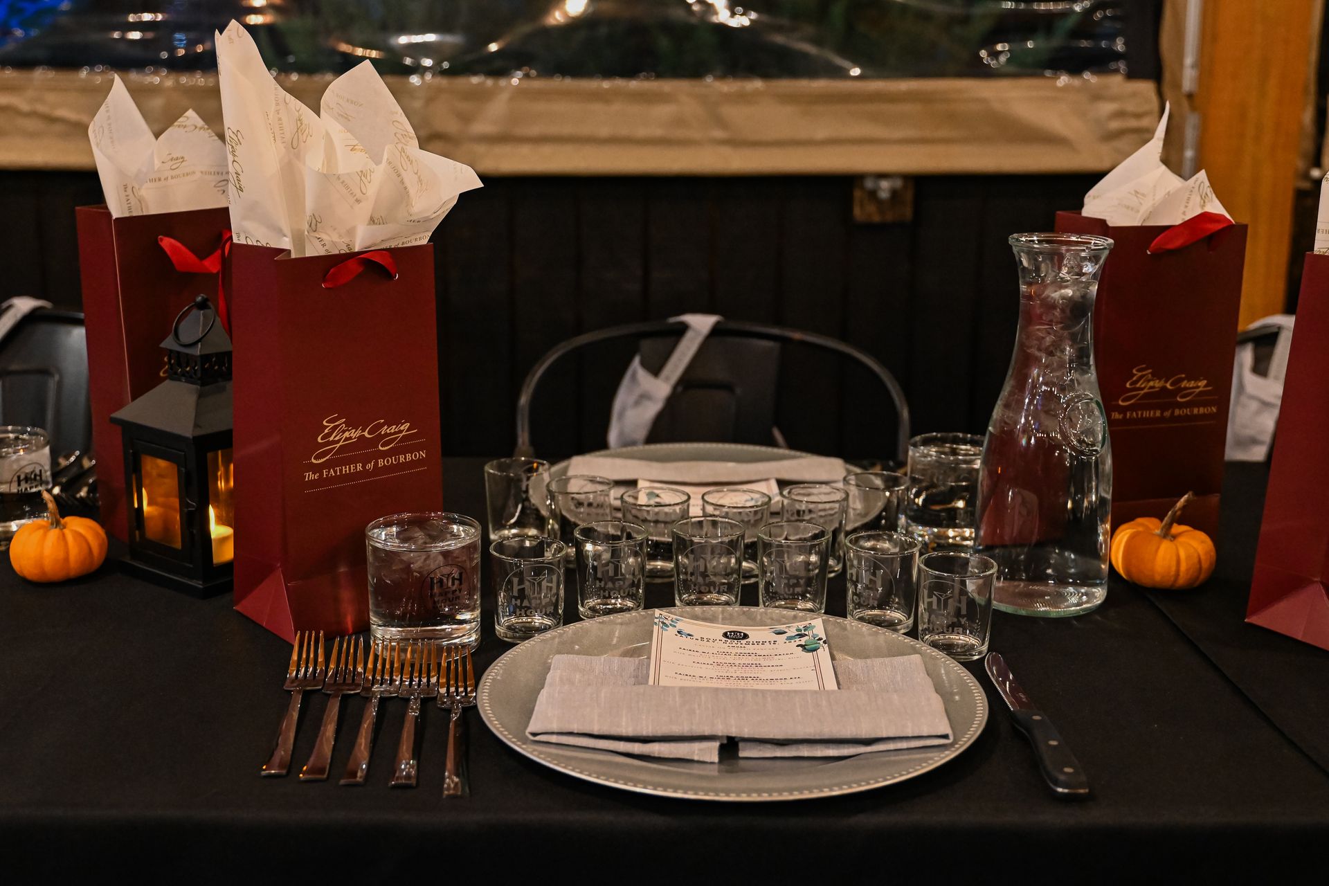 A table set for a party with plates , glasses , and tissues.