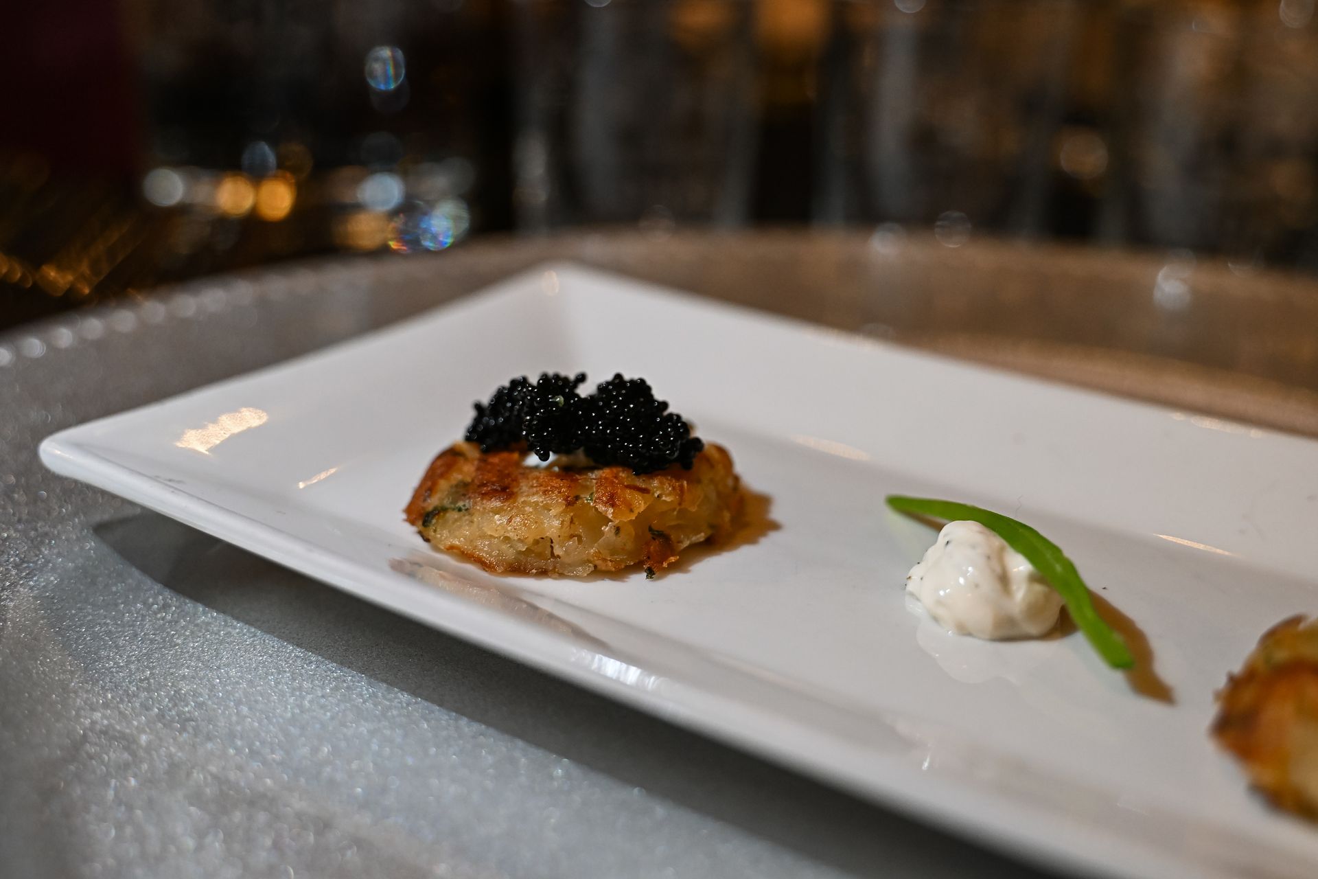 A close up of a white plate topped with food on a table.