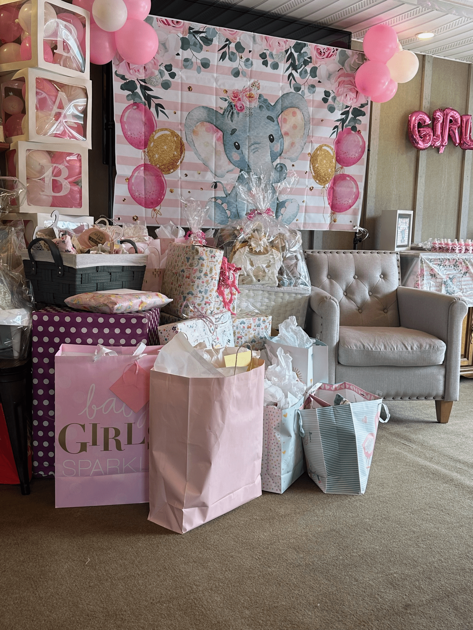 A room filled with lots of gifts and balloons for a baby shower at Happy Hour Bar & Grill