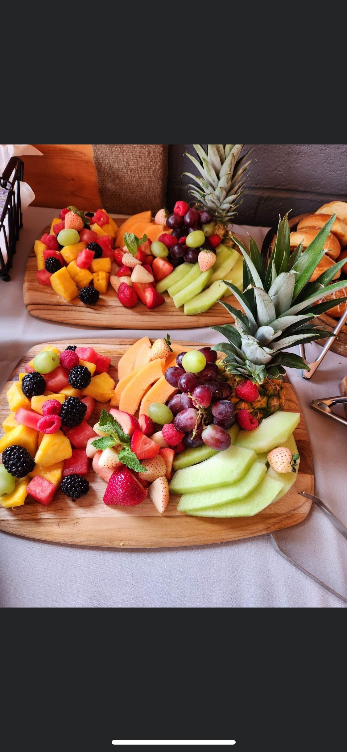 There are many different types of fruit on the cutting boards from Happy Hour Bar & Grill.
