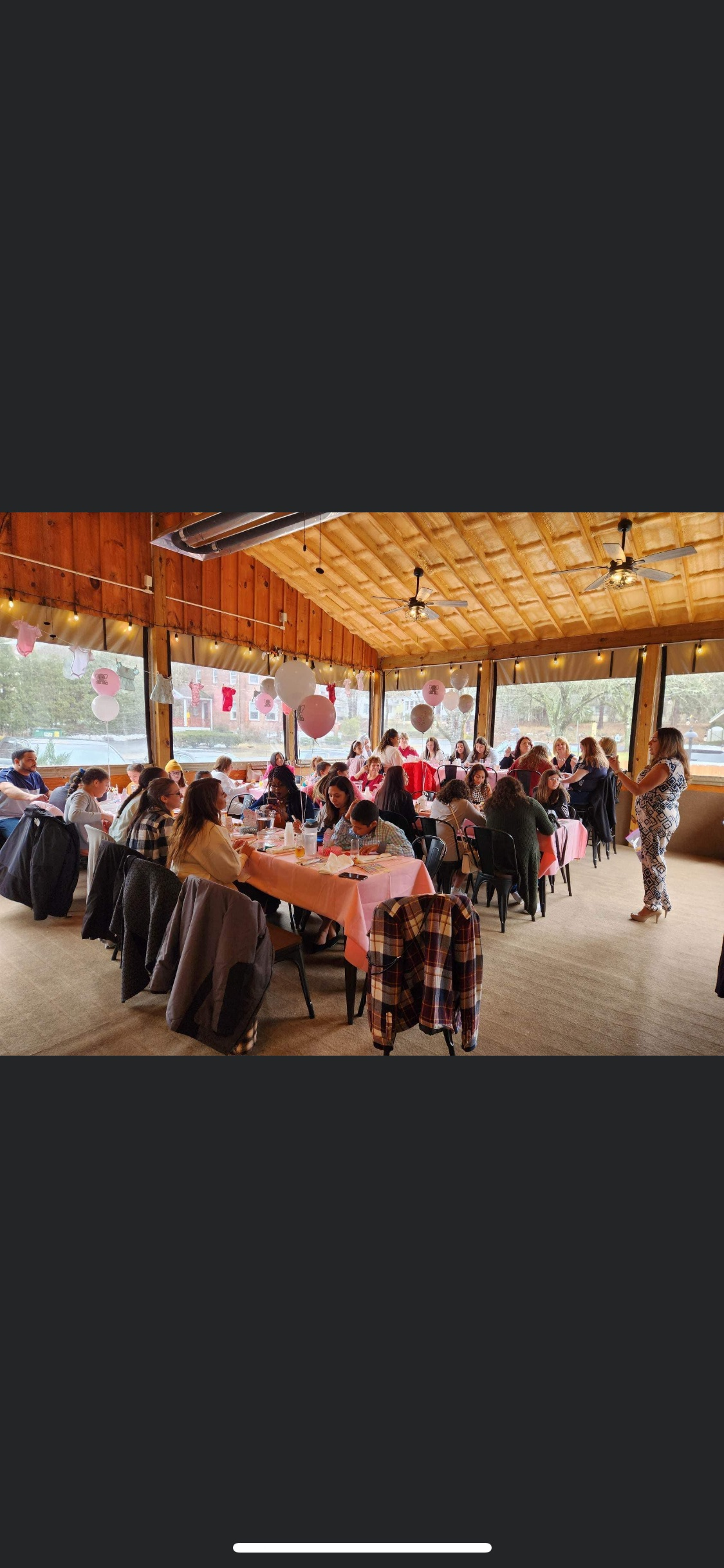 A large group of people are sitting at tables in a large room at Happy Hour Bar & Grill