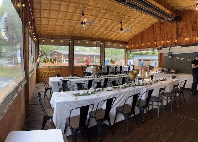 A large room with tables and chairs set up for a wedding reception at Happy Hour Bar & Grill