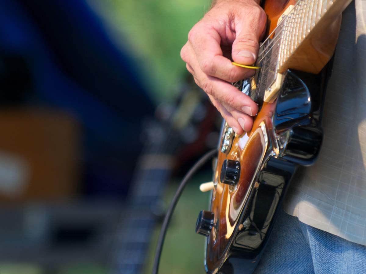 A patio with tables and chairs and umbrellas on a sunny day.