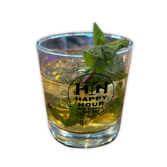 A glass filled with a drink and mint leaves from Happy Hour Bar & Grill.