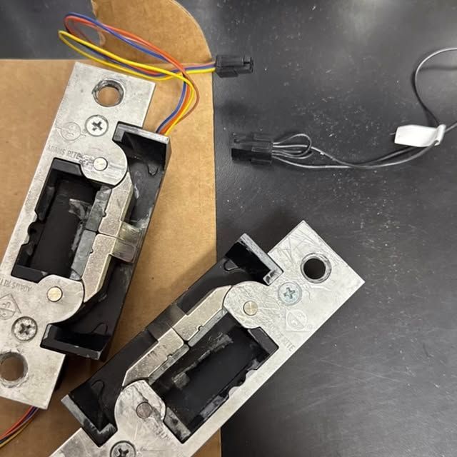 A close up of a piece of metal with a x on it