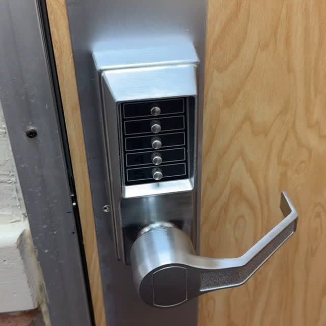 A close up of a door lock on a wooden door