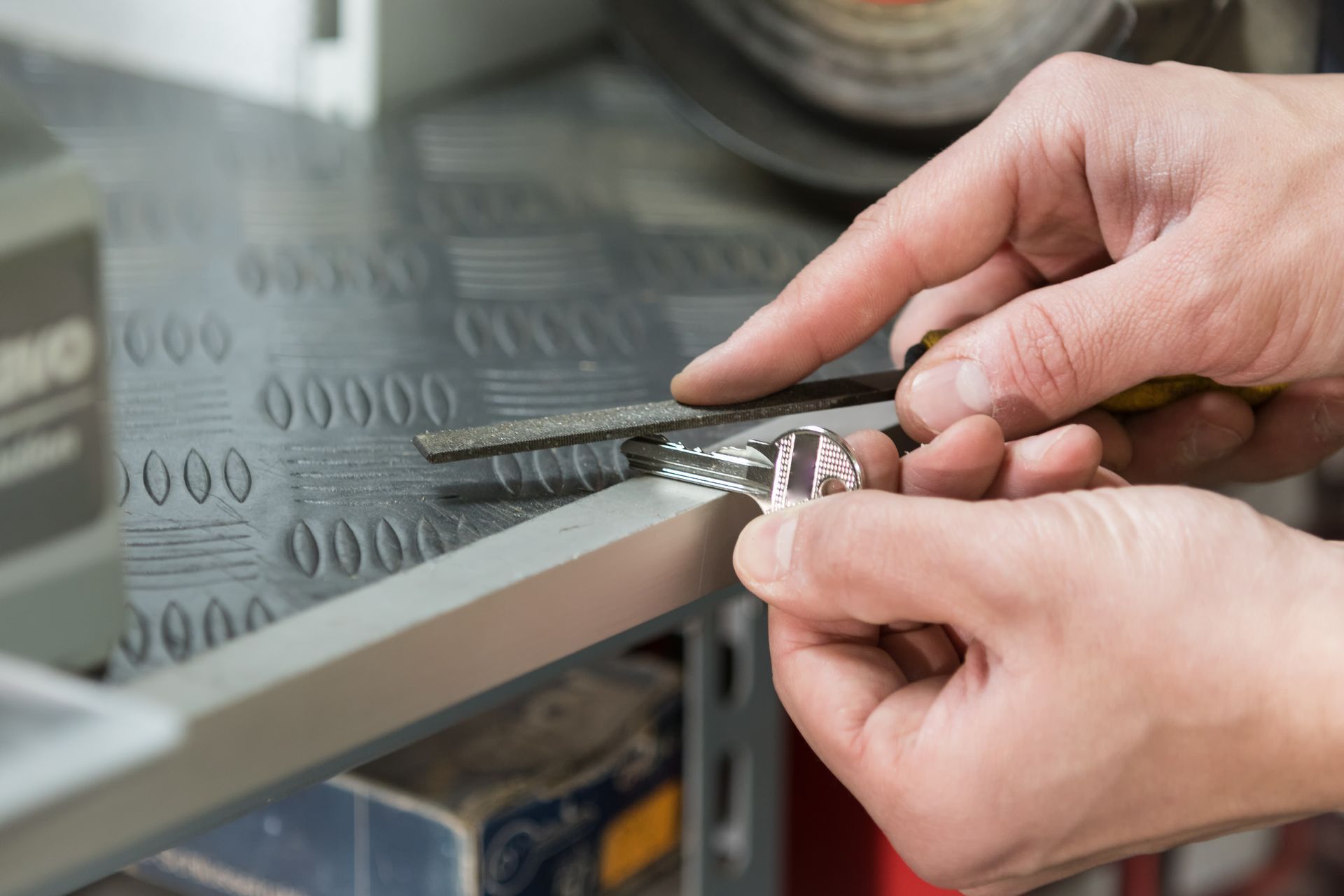 A person is cutting a wire with a pair of pliers.
