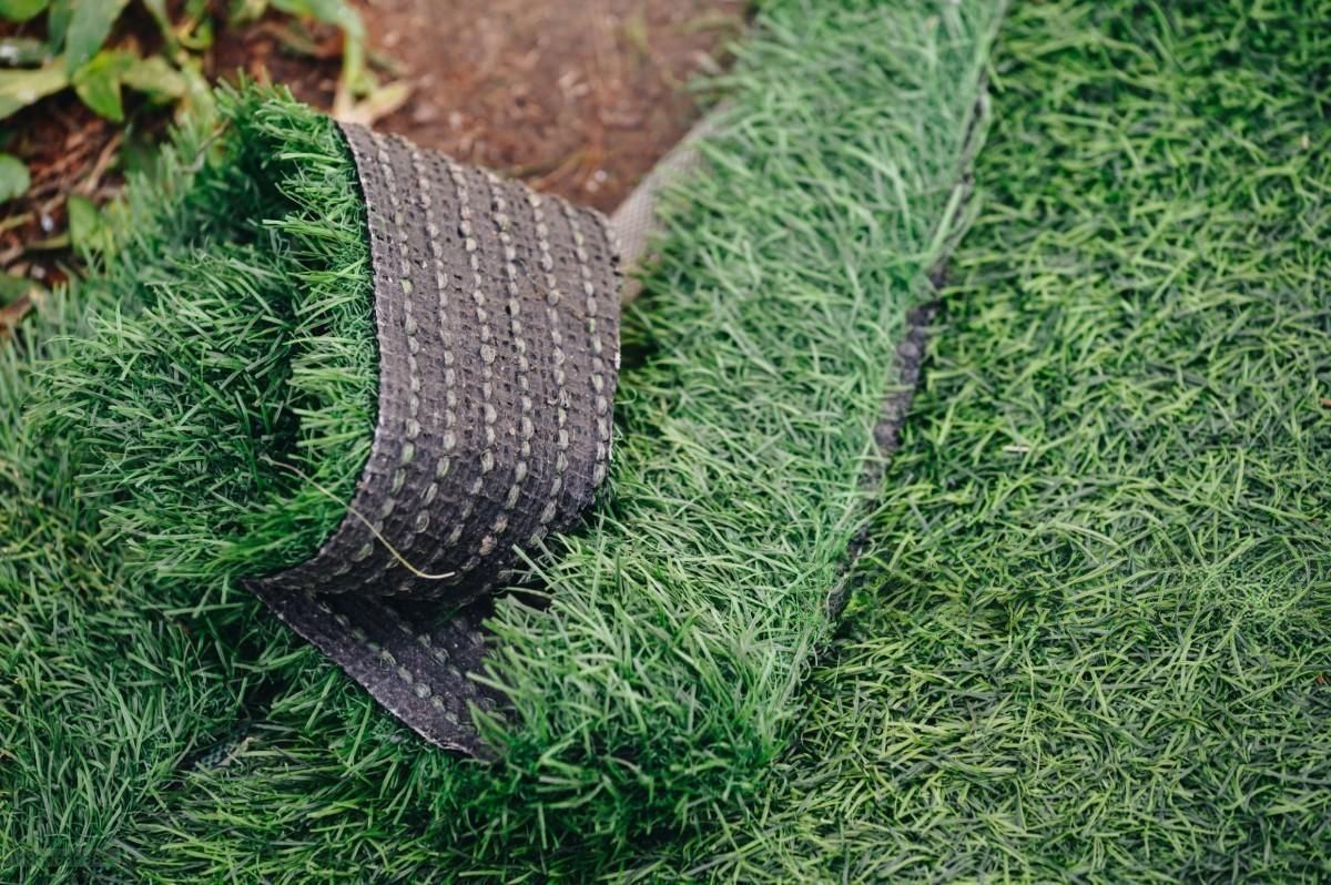 a roll of artificial grass is laying on the ground