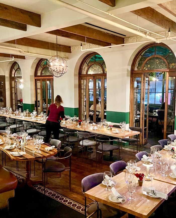 Setting tables for a group event at Allegro Restauraurant in San Diego. 