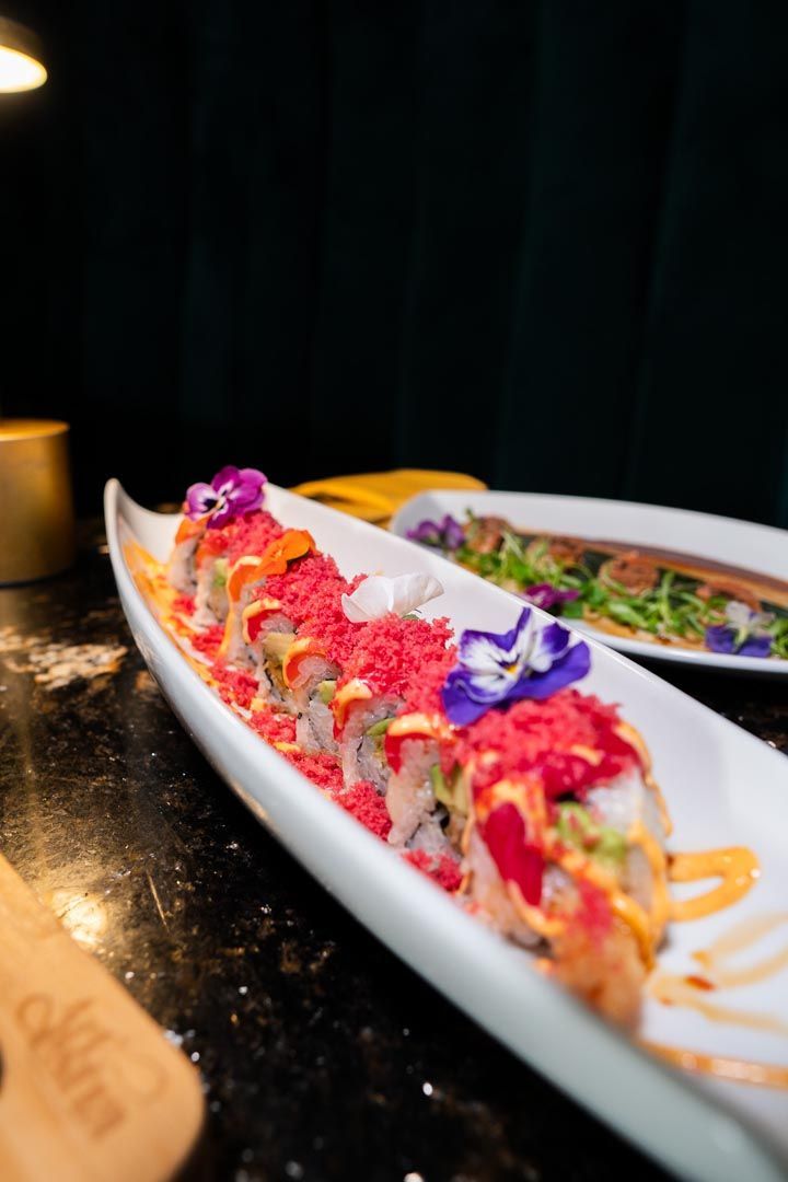A close up of a plate of sushi on a table.